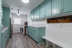 Mint green and white laundry room with mudroom, counter space, oversized,